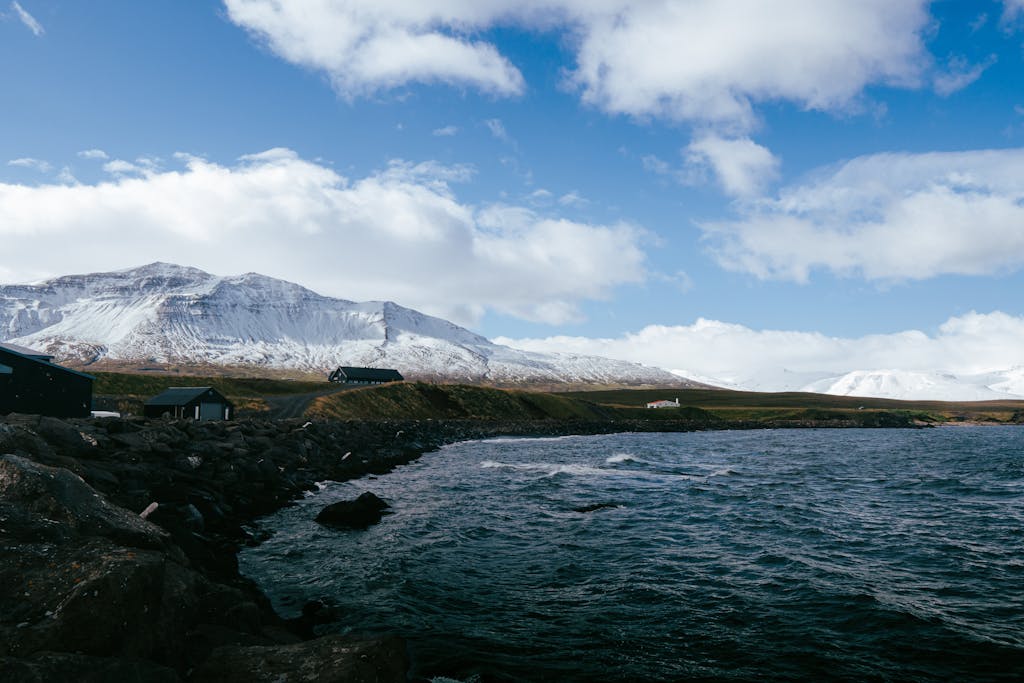 A beautiful winter landscape featuring Icelandic fjords and snowy mountains near Árskógssandur.